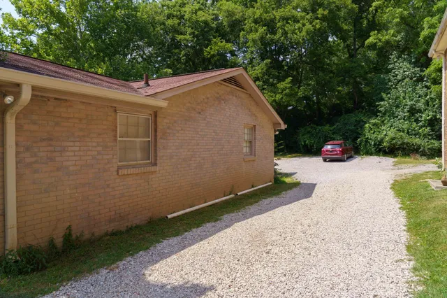 a view of backyard with outdoor seating and trees