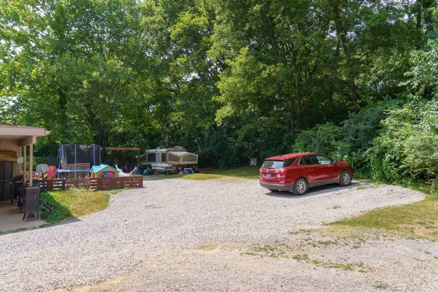 a view of a backyard with table and chairs and potted plants