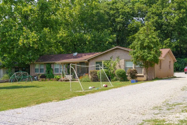a view of a house with a yard and plants