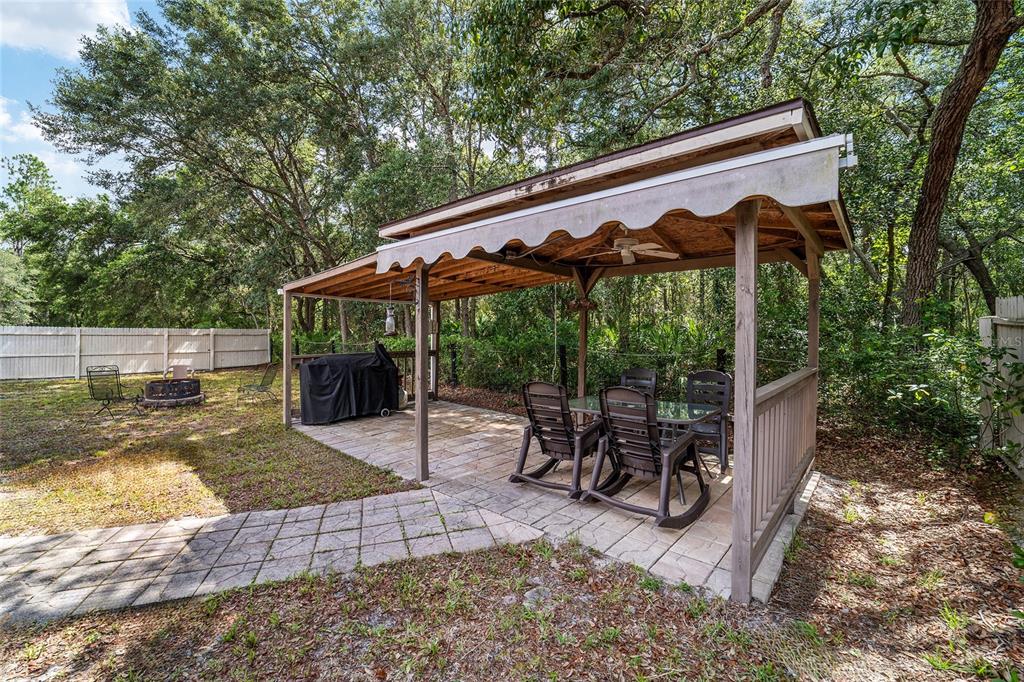 15755 Southwest 90th Avenue Dunnellon, FL 34432 - Photo 38 of 55 a view of a patio with a table chairs and a backyard