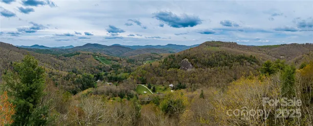 a view of a mountain in the distance in a cloudy sky