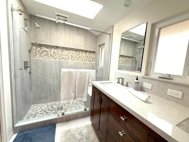 a bathroom with a double vanity sink and a mirror