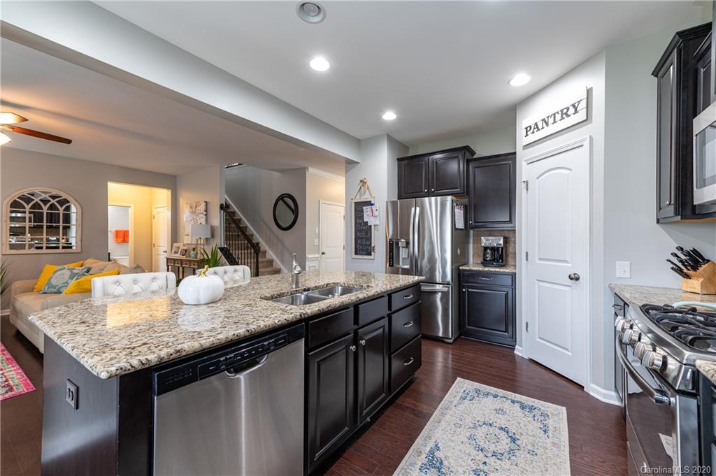 79362 Ridgehaven Road Lancaster, SC 29720 - Photo 11 of 37 a kitchen with stainless steel appliances granite countertop a sink refrigerator and cabinets