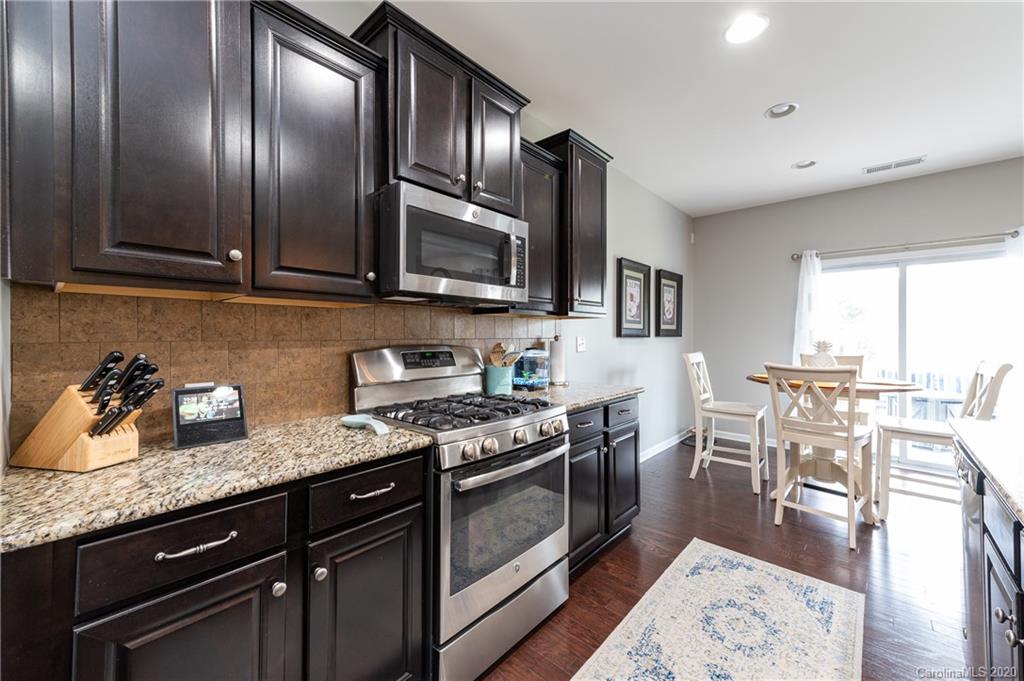 79362 Ridgehaven Road Lancaster, SC 29720 - Photo 12 of 37 a kitchen with granite countertop stainless steel appliances and wooden cabinets