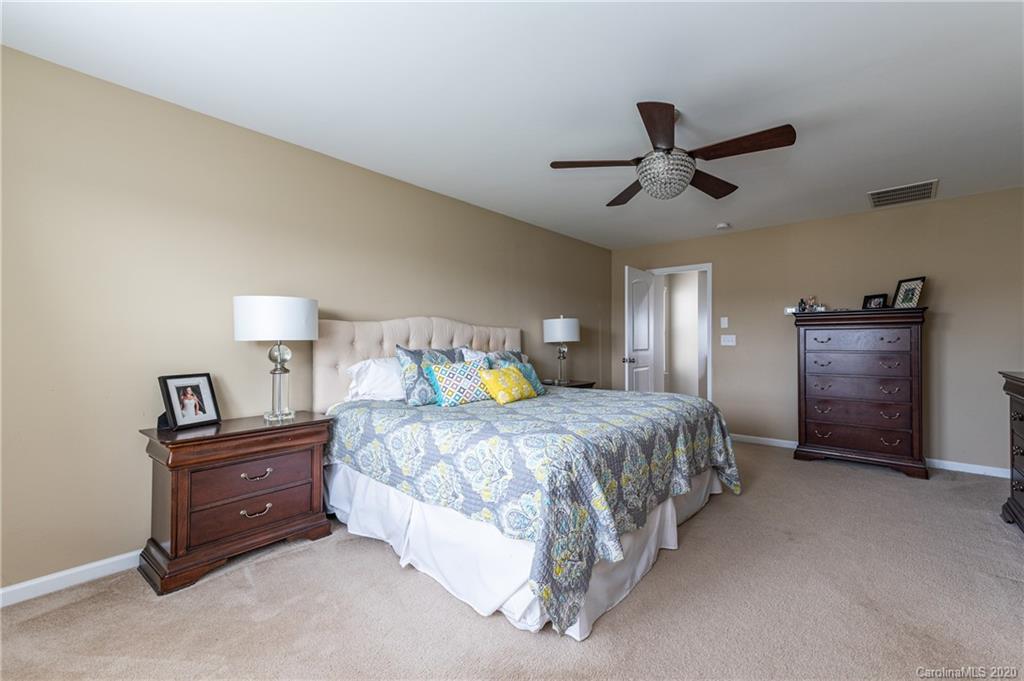 79362 Ridgehaven Road Lancaster, SC 29720 - Photo 22 of 37 a spacious bedroom with a bed and a ceiling fan