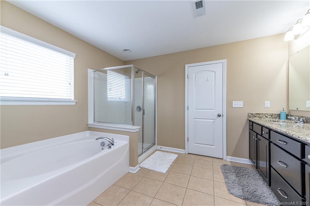 79362 Ridgehaven Road Lancaster, SC 29720 - Photo 24 of 37 a bathroom with a bathtub sink and mirror