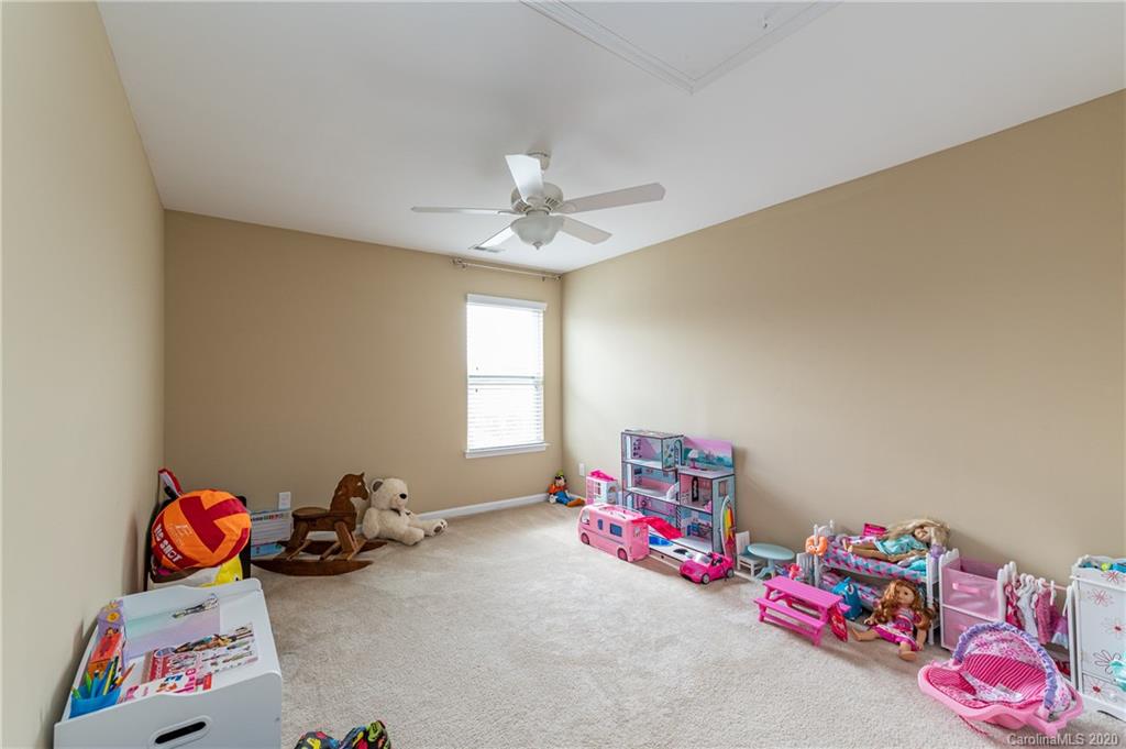 79362 Ridgehaven Road Lancaster, SC 29720 - Photo 27 of 37 a bed room with a bed and a chandelier