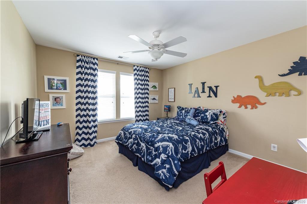 79362 Ridgehaven Road Lancaster, SC 29720 - Photo 29 of 37 a bedroom with a bed and a chandelier