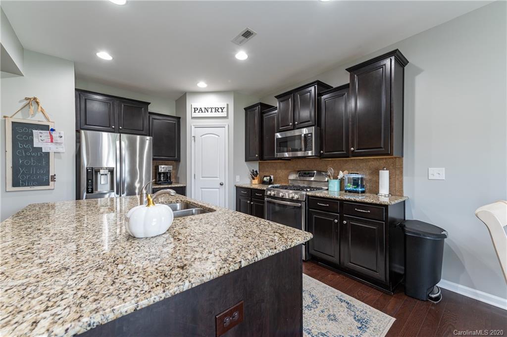 79362 Ridgehaven Road Lancaster, SC 29720 - Photo 9 of 37 a kitchen with a refrigerator and a stove top oven