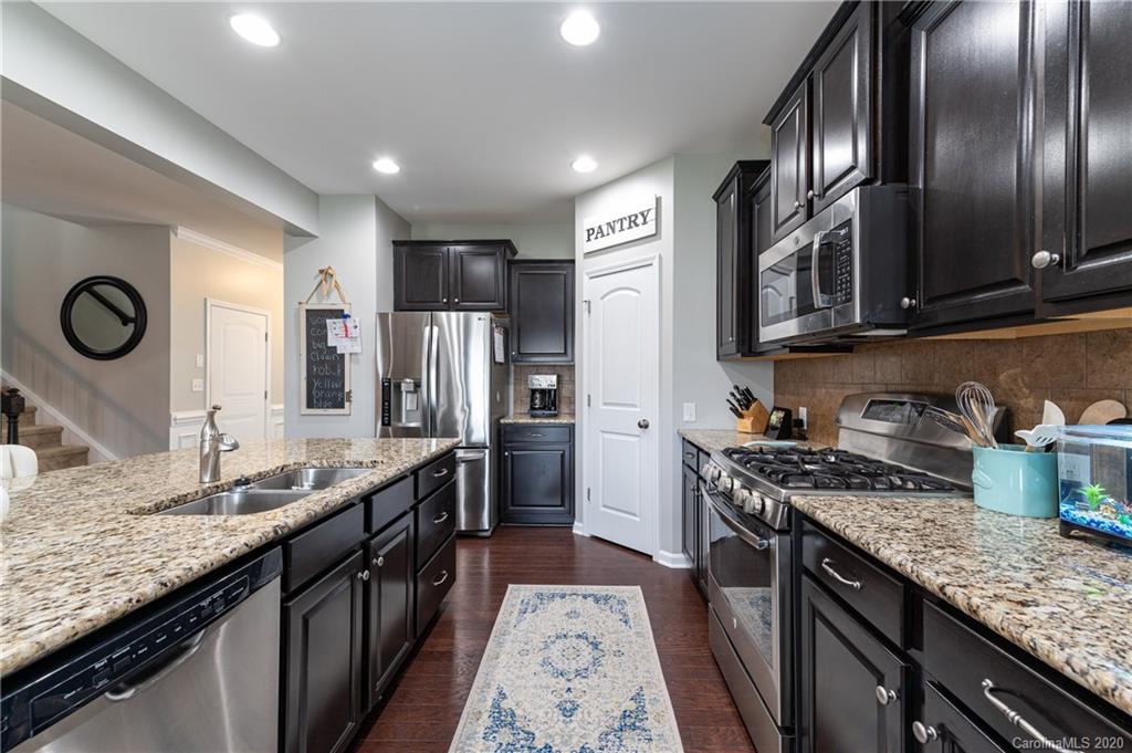 79362 Ridgehaven Road Lancaster, SC 29720 - Photo 10 of 37 a kitchen with stainless steel appliances granite countertop a sink stove and refrigerator