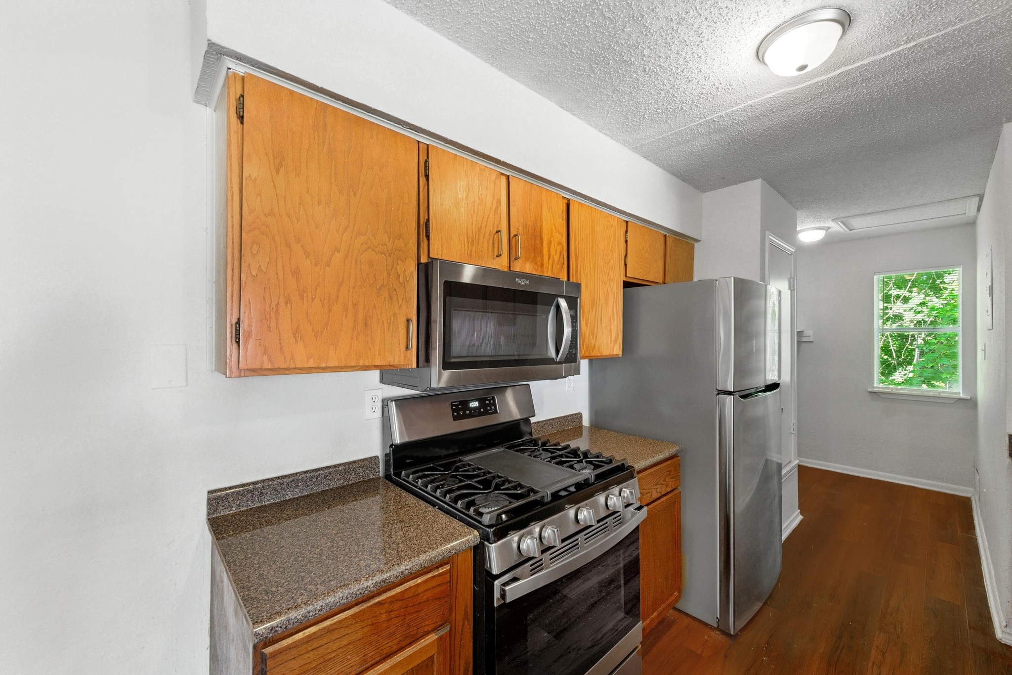5707 Spring Meadow Road Austin, TX 78744 - Photo 12 of 21 a kitchen with a stove and a refrigerator