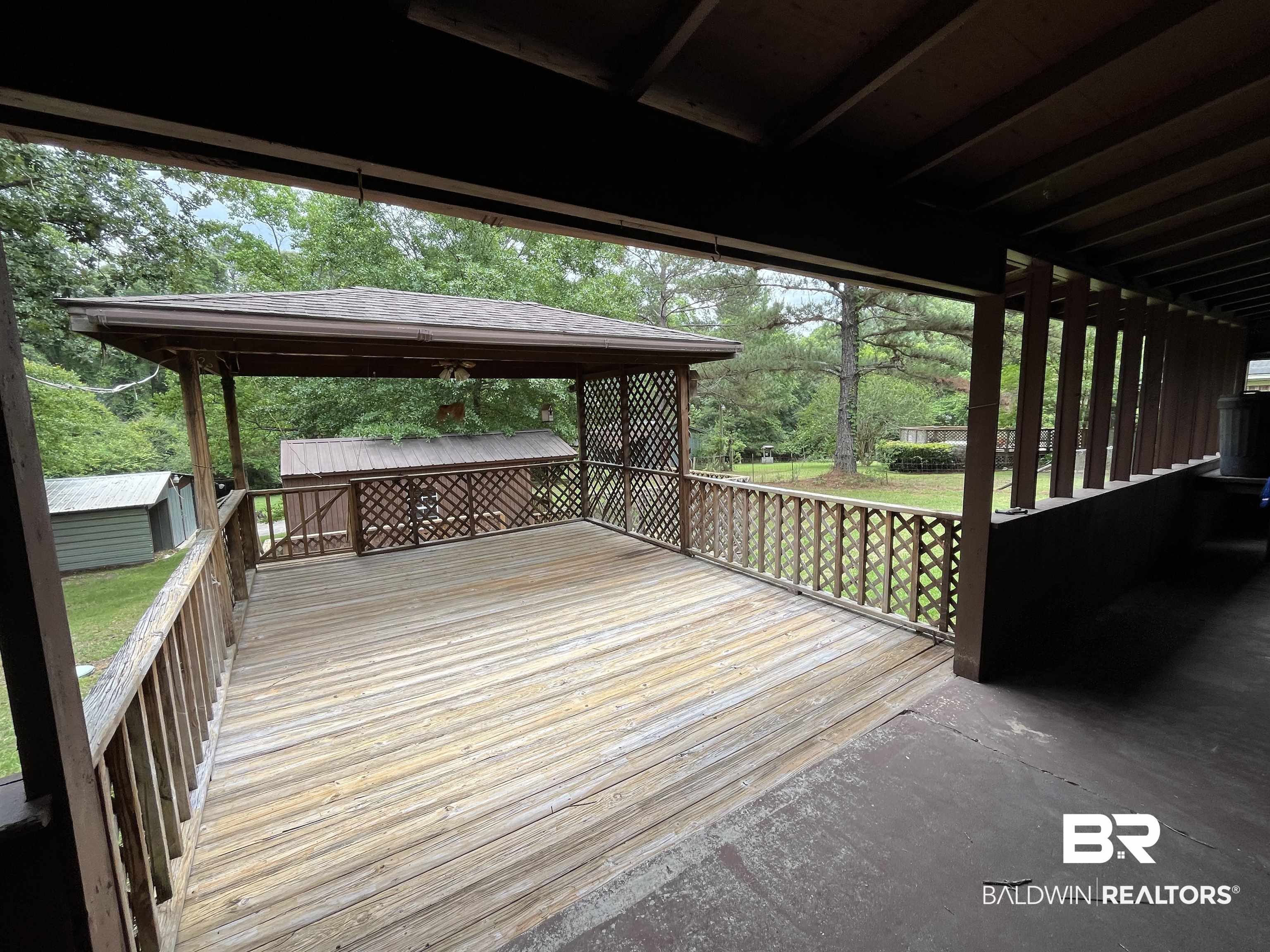 1905 Rockaway Creek Road Atmore, AL 36502 - Photo 15 of 23 Spacious wooden deck with lattice railing, featuring an adjacent covered gazebo and direct access to a grassy yard