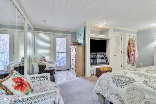a bedroom with bed and glass door