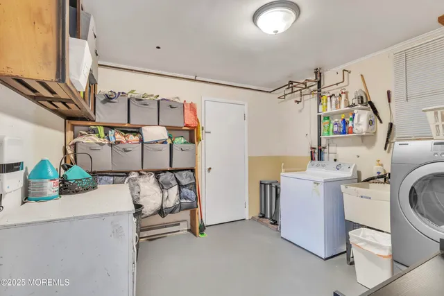 a utility room with cabinets dryer and washer