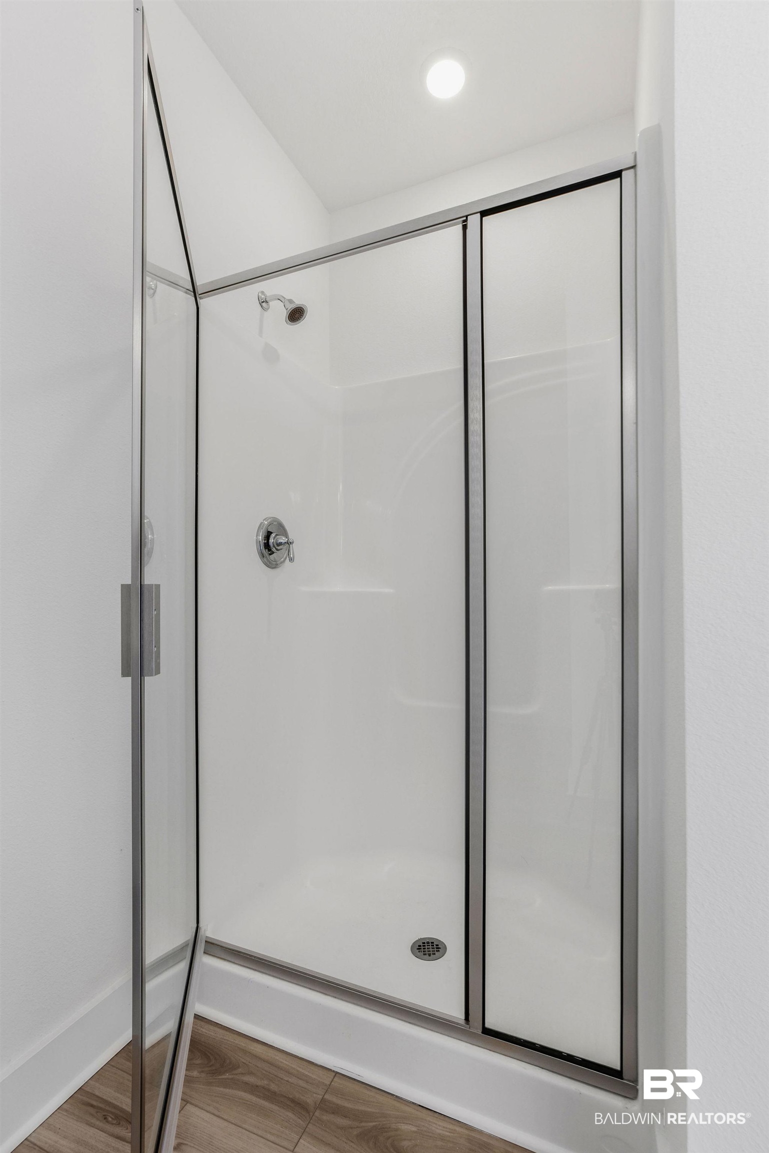 9859 Willet Way Foley, AL 36535 - Photo 14 of 23 Full bathroom with a stall shower and wood finished floors