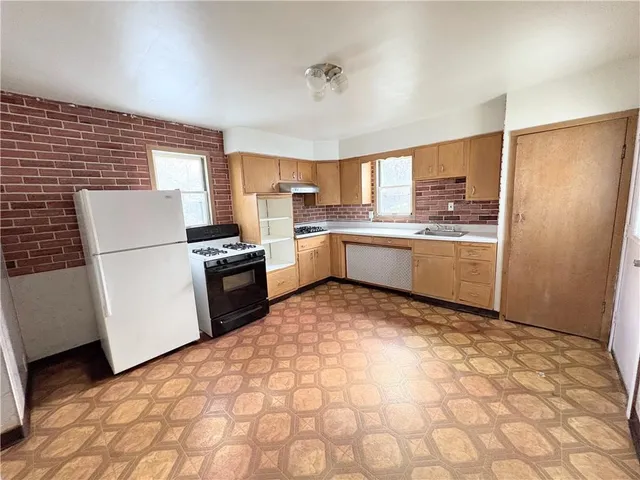 a kitchen with a refrigerator sink and stove
