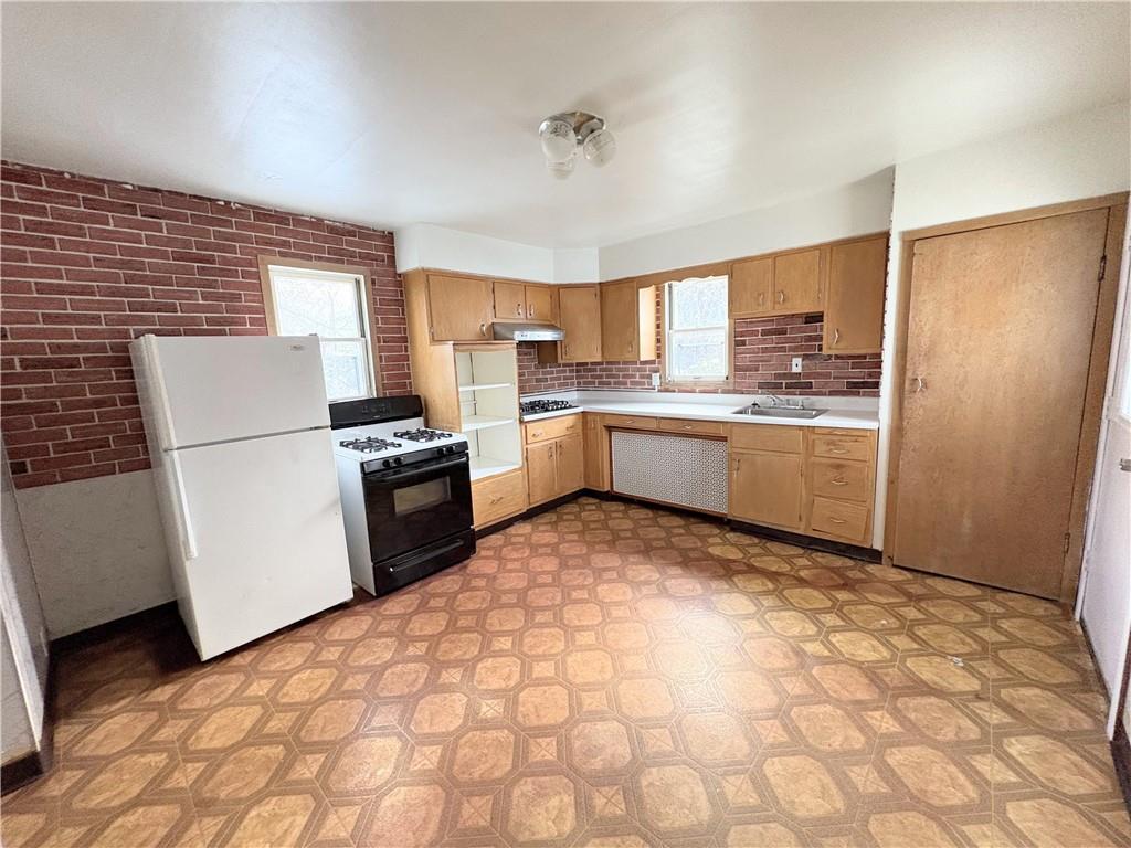 1604 Ridge Avenue, Unit 2 Braddock, PA 15104 - Photo 2 of 6 a kitchen with a refrigerator sink and stove
