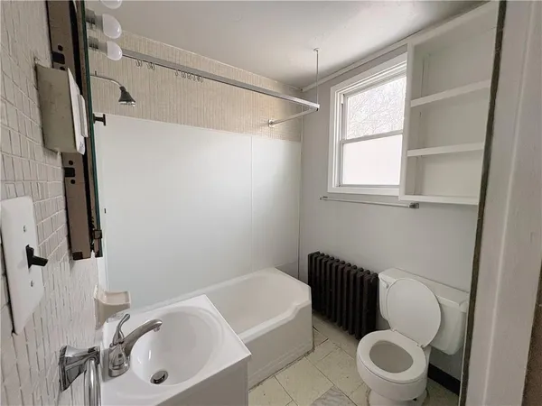 a bathroom with a sink a toilet and a bathtub