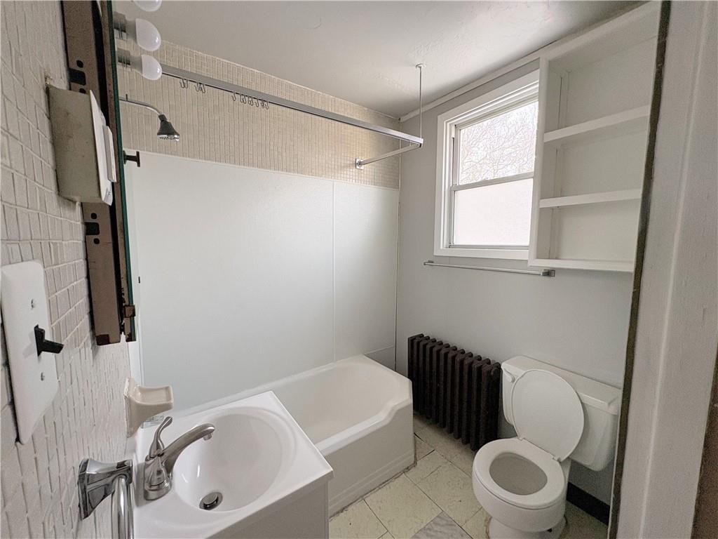 1604 Ridge Avenue, Unit 2 Braddock, PA 15104 - Photo 4 of 6 a bathroom with a sink a toilet and a bathtub