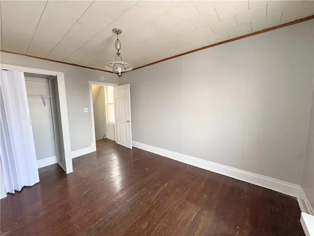a view of a room with wooden floor and window
