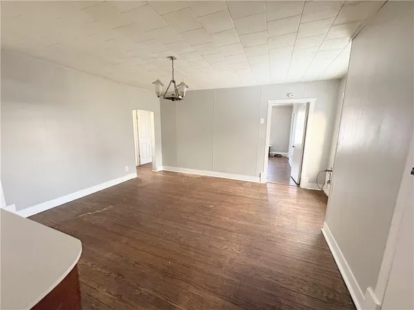 a view of a room with wooden floor