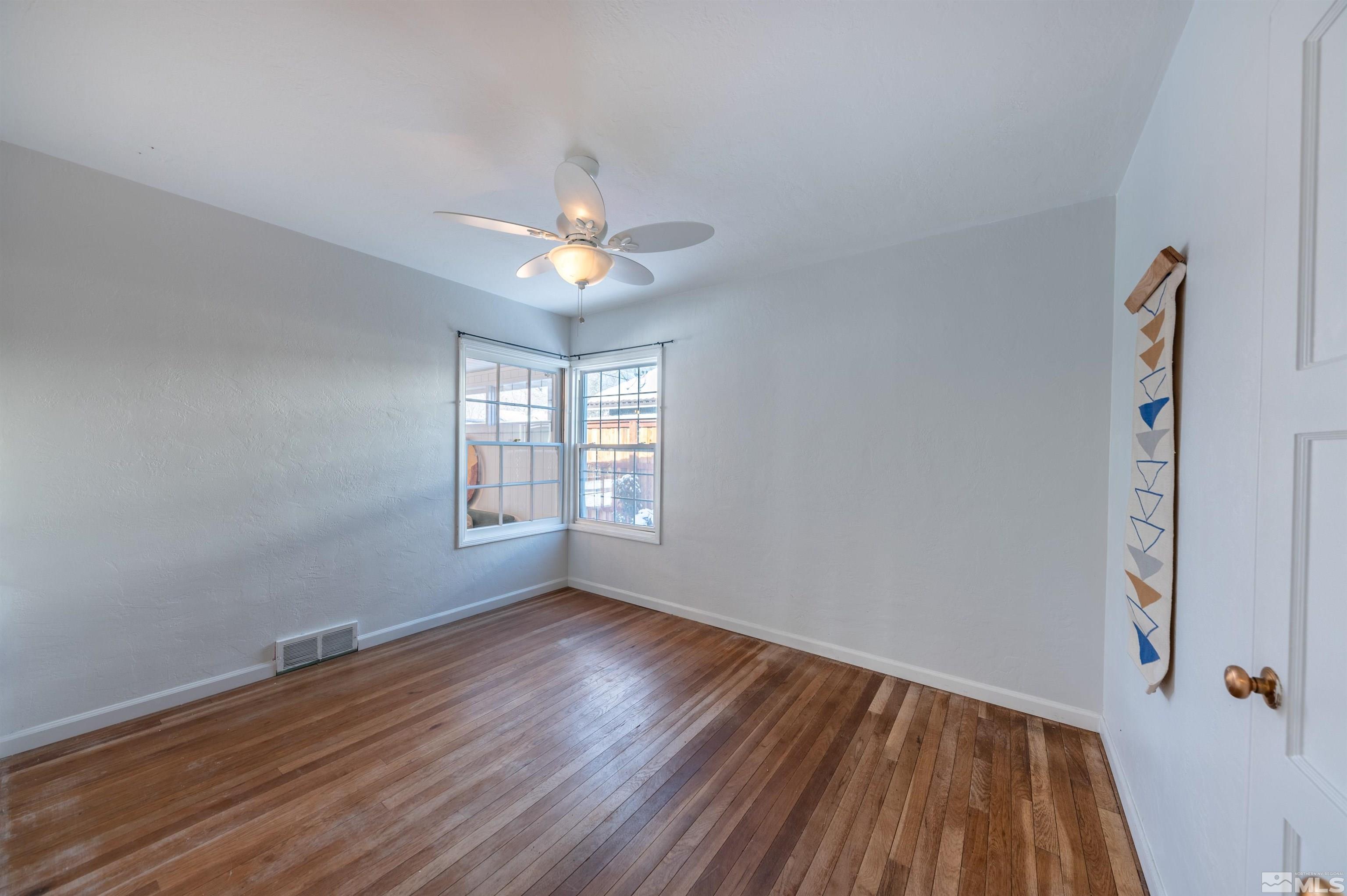 997 Meadow Street Reno, NV 89509 - Photo 20 of 33 a view of an empty room with wooden floor and a window