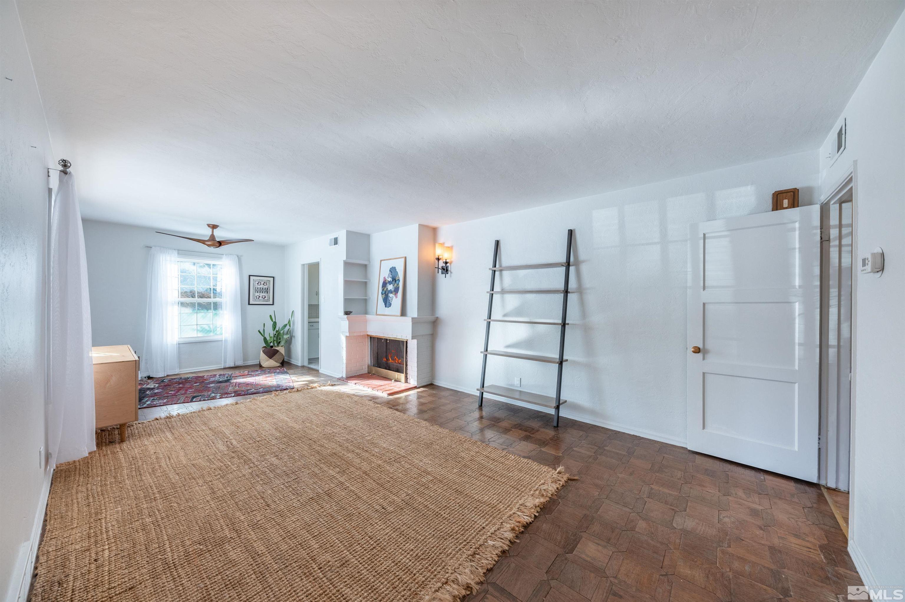997 Meadow Street Reno, NV 89509 - Photo 8 of 33 a spacious bedroom with a bed and a window