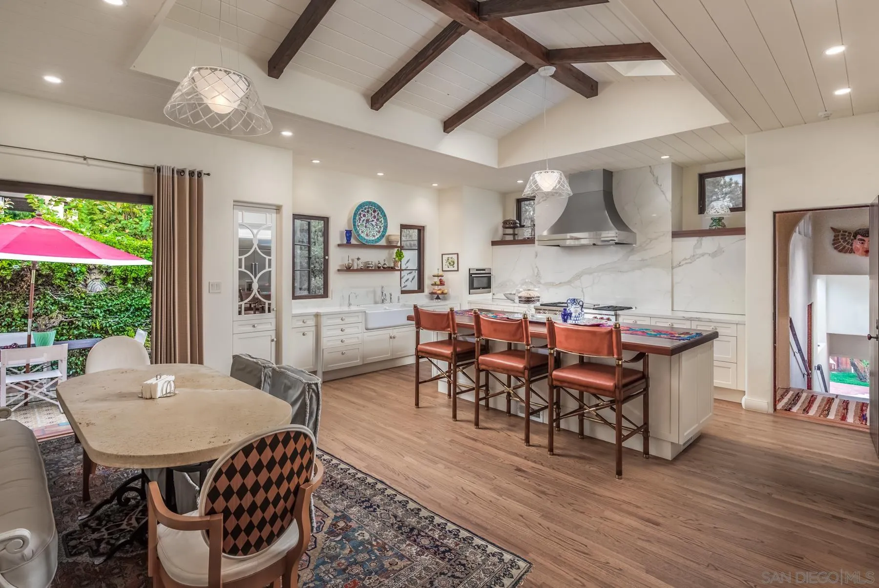545 Rimini Road Del Mar, CA 92014 - Photo 13 of 34 a view of a dining room with furniture window and wooden floor