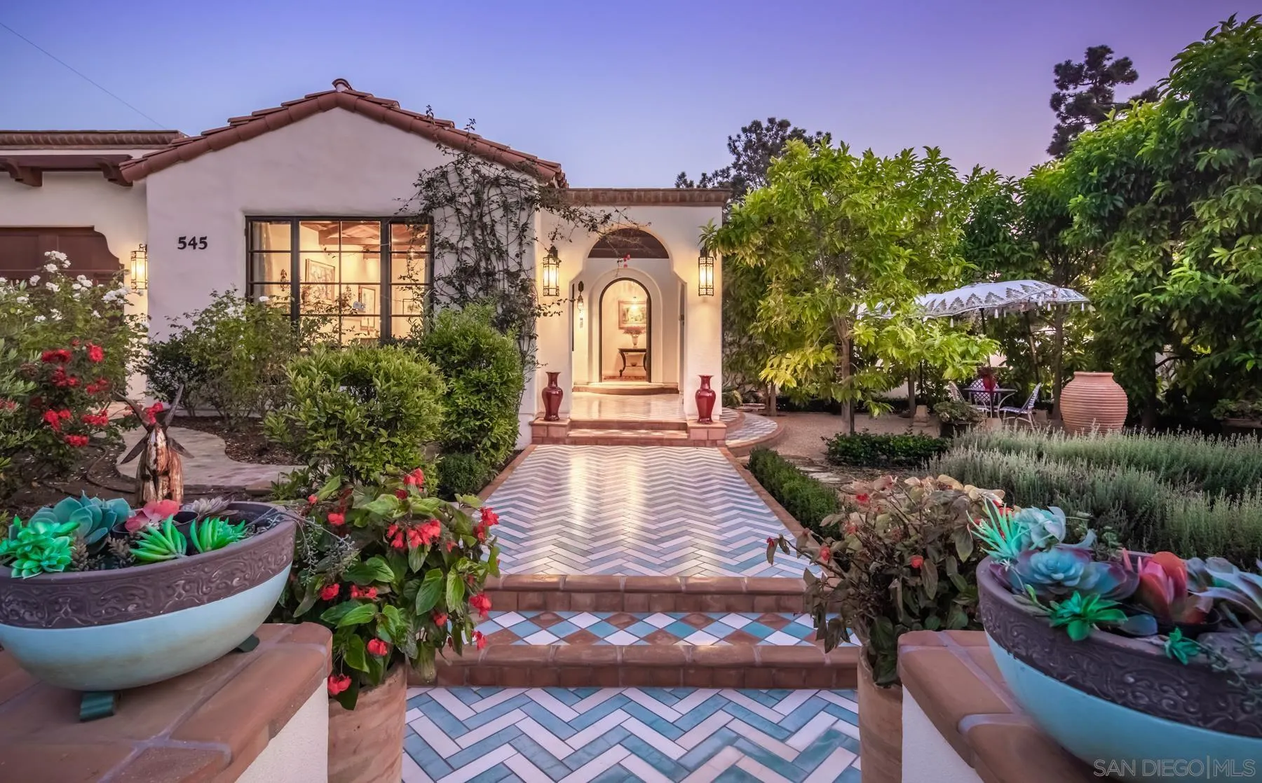 545 Rimini Road Del Mar, CA 92014 - Photo 3 of 34 a front view of a house with a yard