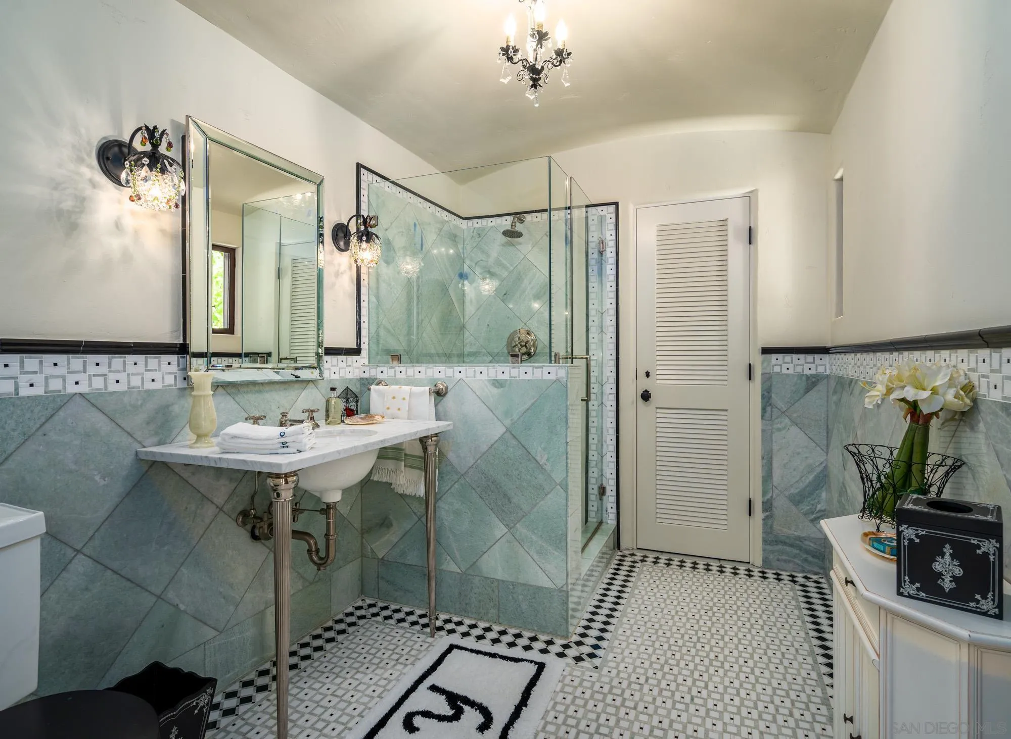 545 Rimini Road Del Mar, CA 92014 - Photo 9 of 34 a bathroom with a sink a mirror and a shower