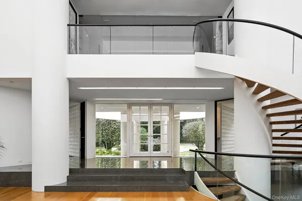 a view of entryway and hall with wooden floor
