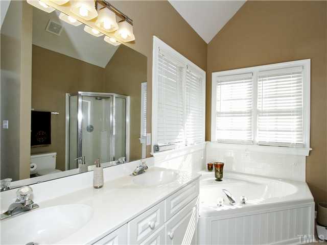 3521 Catlett Farm Road Wake Forest, NC 27587 - Photo 13 of 25 Master bath has beautiful cathedral ceiling, double vanities, shower and garden tub.