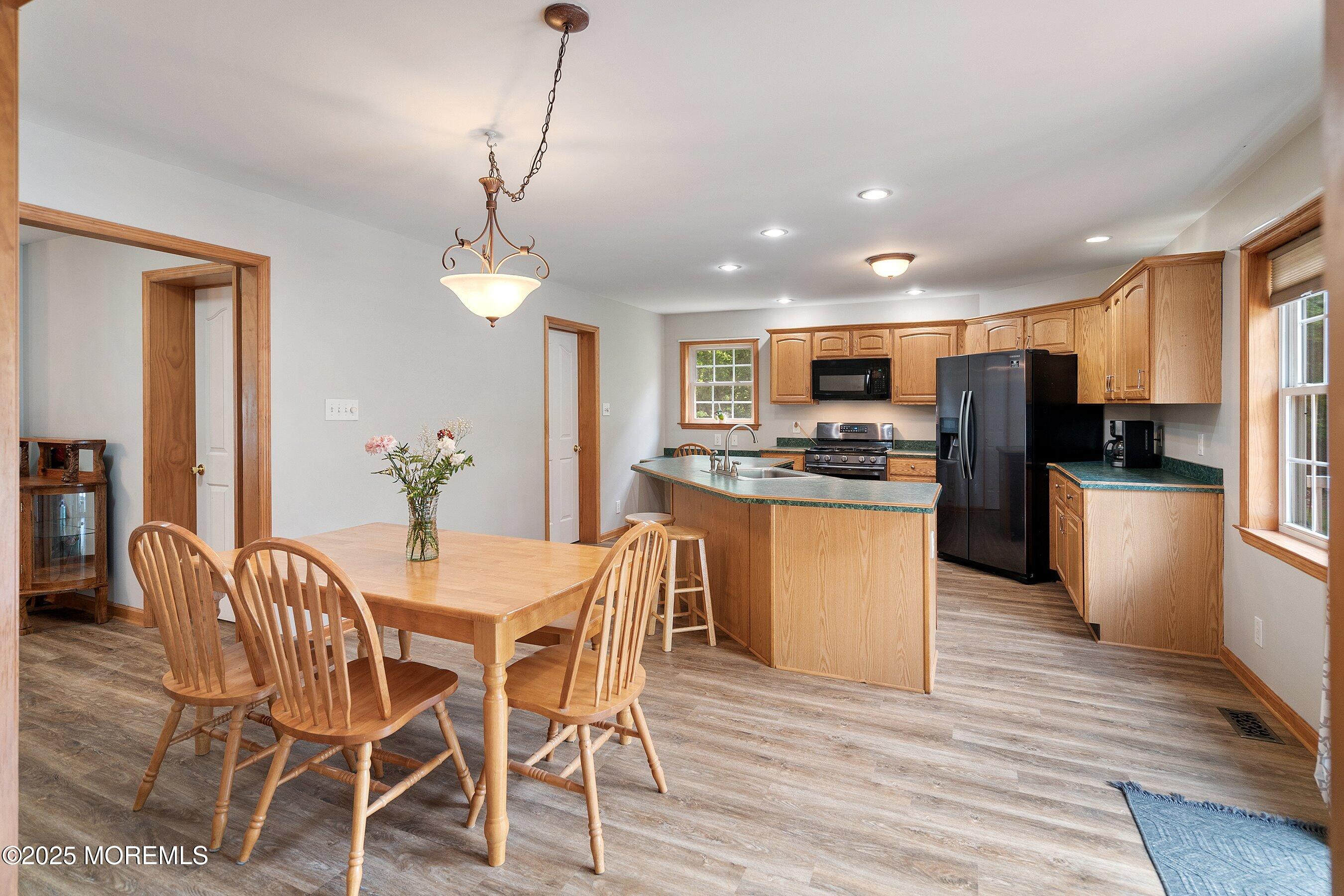 10 Hillside Avenue Tuckerton, NJ 08087 - Photo 13 of 46 a kitchen with microwave a refrigerator and chairs