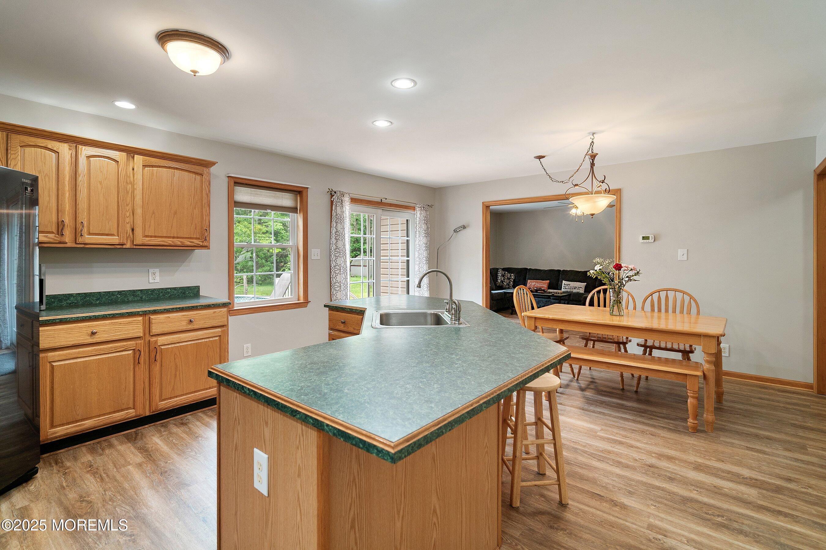 10 Hillside Avenue Tuckerton, NJ 08087 - Photo 15 of 46 a kitchen with a table chairs sink and wooden floor