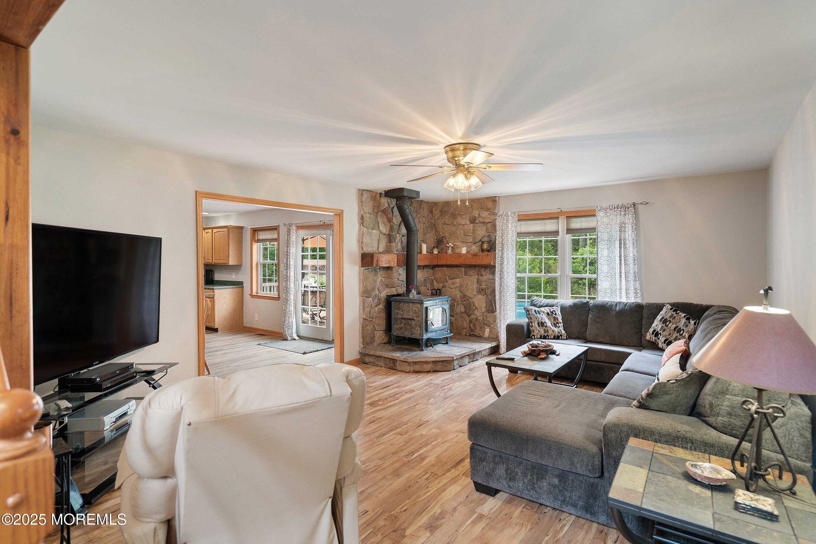 10 Hillside Avenue Tuckerton, NJ 08087 - Photo 18 of 46 a living room with furniture a fireplace and a flat screen tv