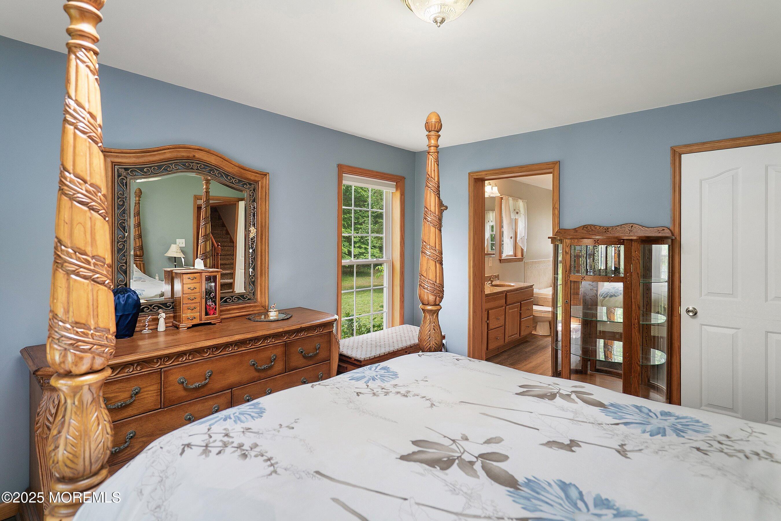 10 Hillside Avenue Tuckerton, NJ 08087 - Photo 21 of 46 a bedroom with a balcony a bed and a dresser with mirror