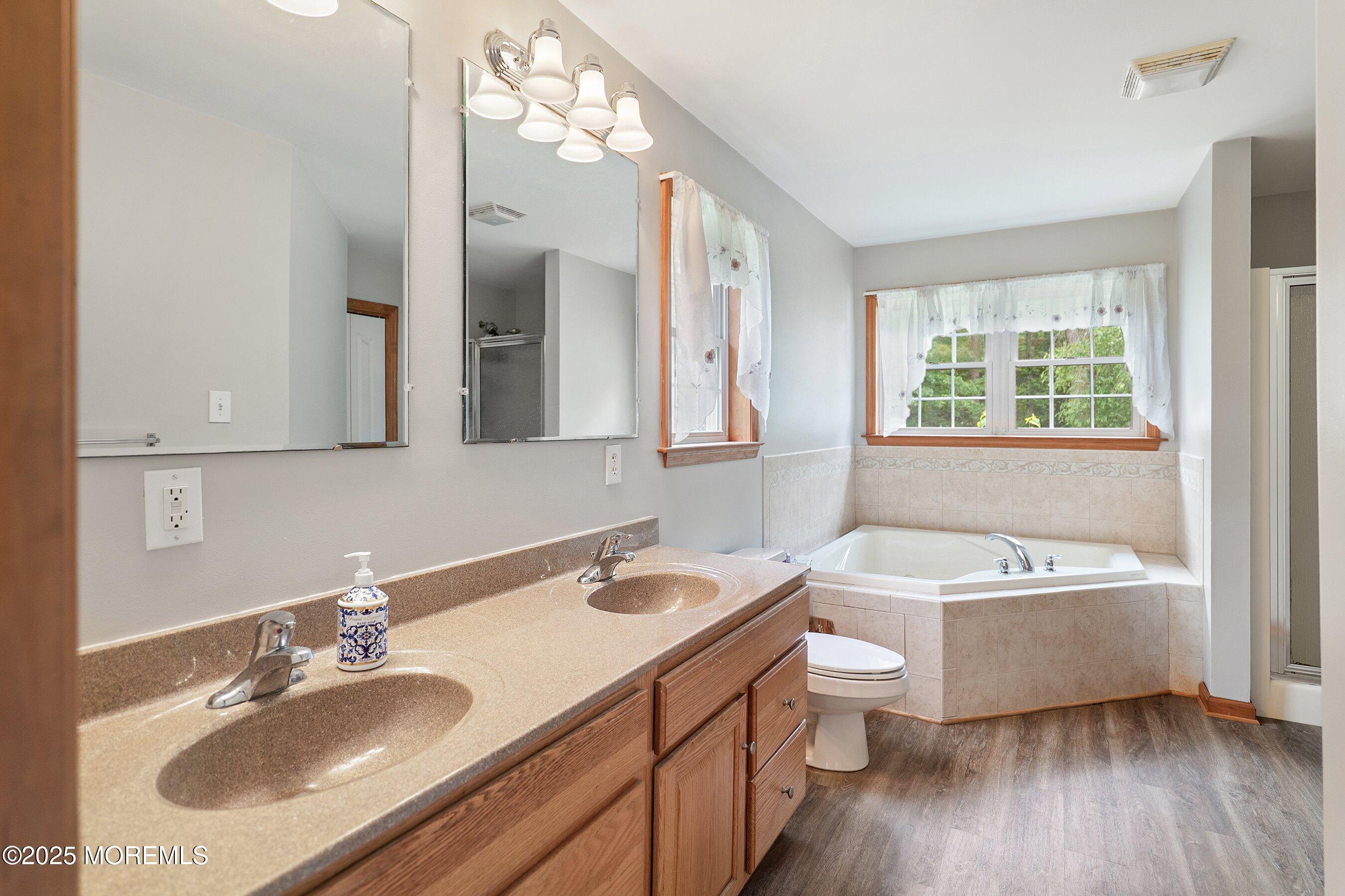 10 Hillside Avenue Tuckerton, NJ 08087 - Photo 22 of 46 a bathroom with a sink double vanity granite tub and a mirror