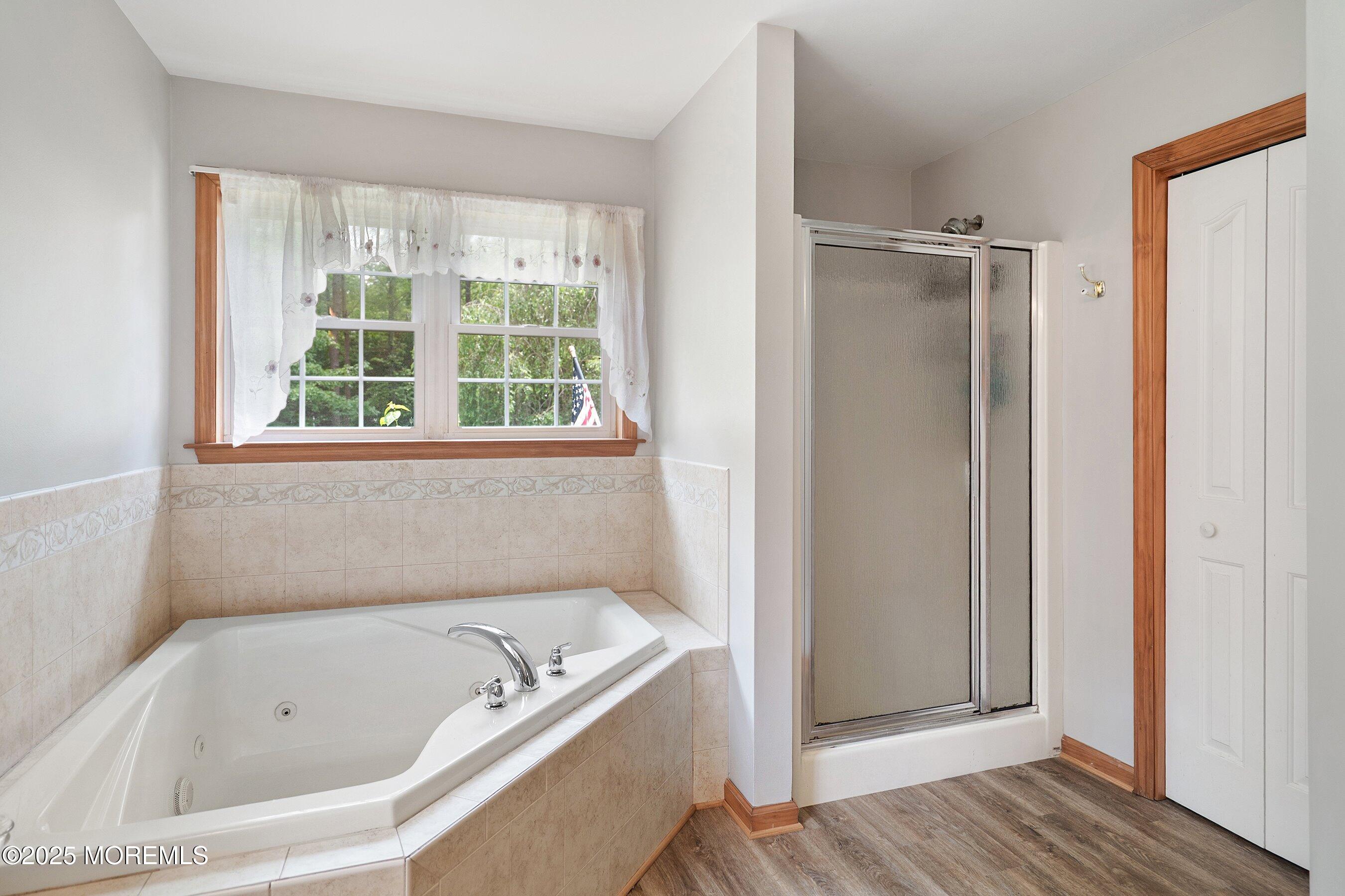 10 Hillside Avenue Tuckerton, NJ 08087 - Photo 23 of 46 a bathroom with a tub a sink and a window
