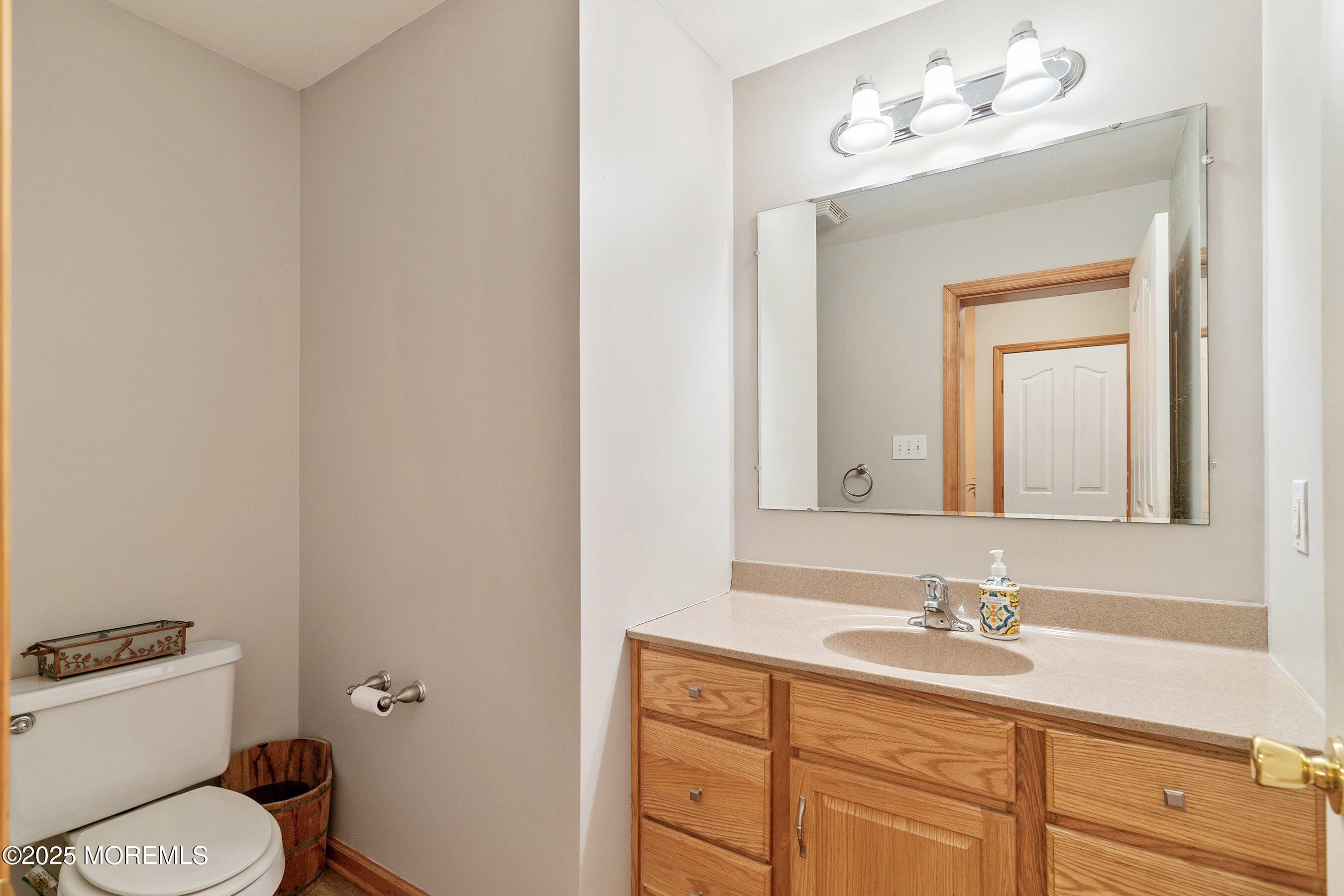 10 Hillside Avenue Tuckerton, NJ 08087 - Photo 25 of 46 a bathroom with a toilet sink and mirror