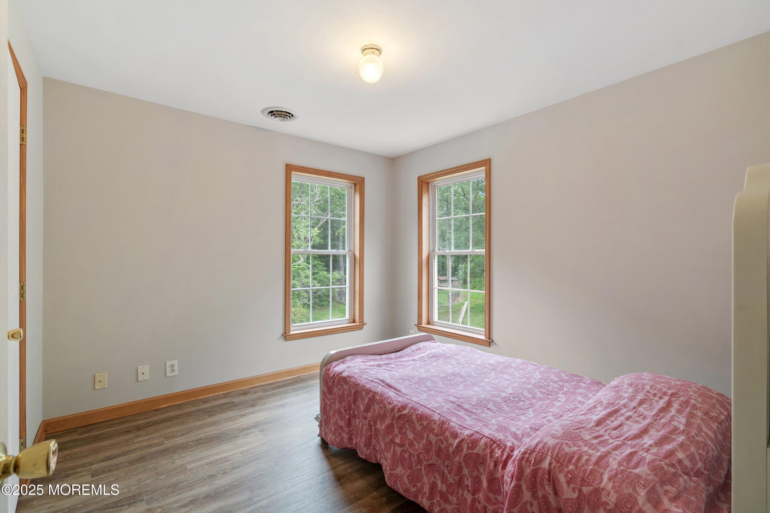 10 Hillside Avenue Tuckerton, NJ 08087 - Photo 34 of 46 a bedroom with a bed and wooden floor