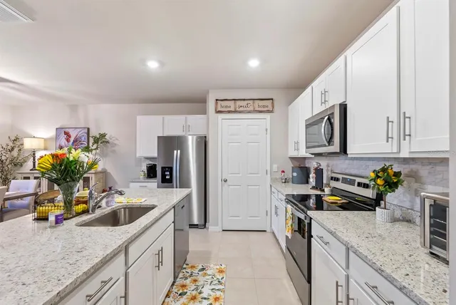 a living room with patio furniture and a potted plant