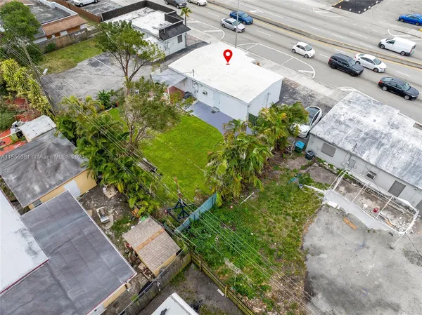 an aerial view of a house with a yard and garden