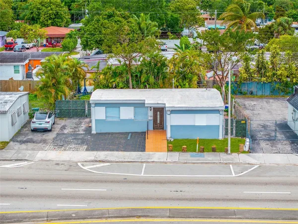an aerial view of a house with swimming pool and porch