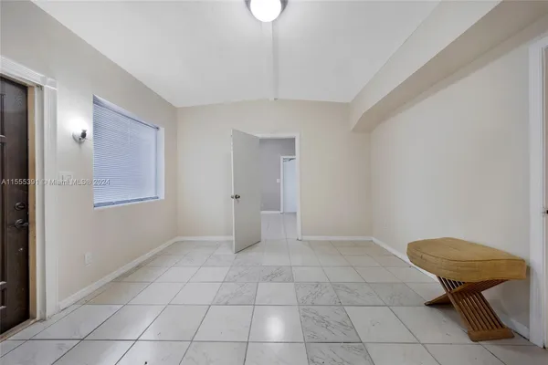 a view of an empty room with glass door