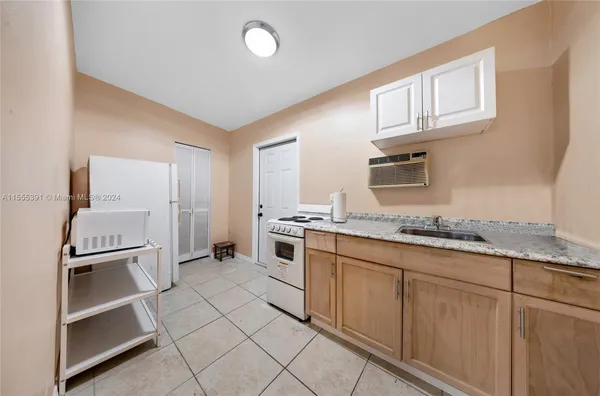a kitchen with sink and cabinets