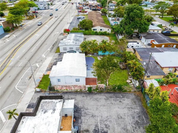 an aerial view of a house with a yard and lake view