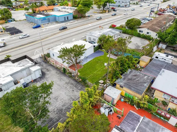 an aerial view of a houses with yard