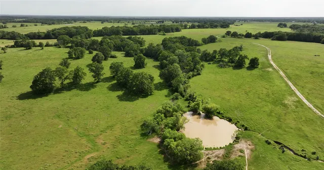 a roof deck with table and chairs under an umbrella