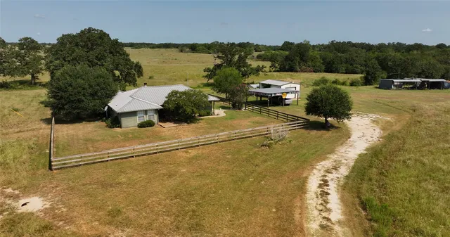 a view of a house with pool and chairs