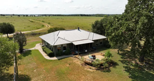 a swimming pool with outdoor seating and lake view